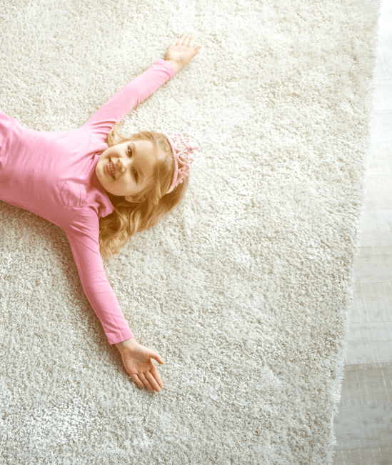 Cute girl laying on rug | CarpetsPlus COLORTILE of Wyoming
